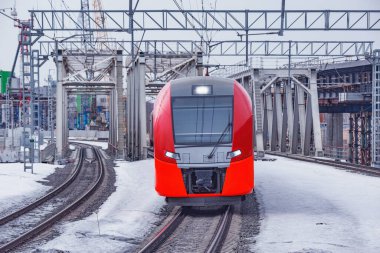 Highspeed train moves through the bridge at winter day. MCC. Moscow. Russia. clipart