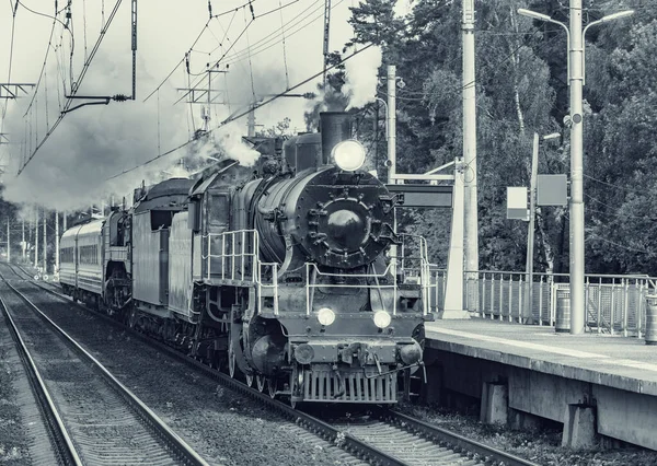 Retro train departs from the platform. Moscow region. Russia.