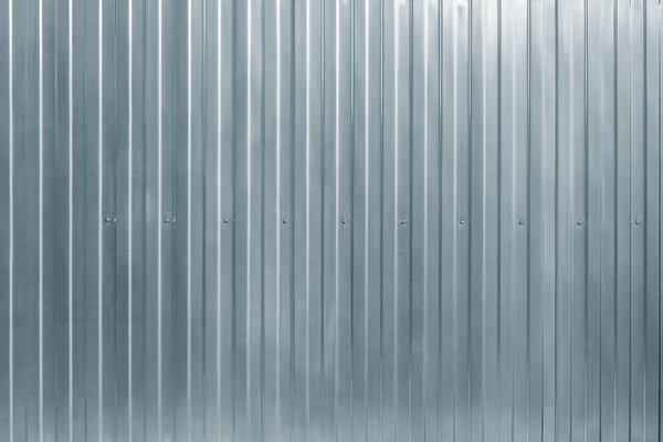 Gray corrugated metal fence background.