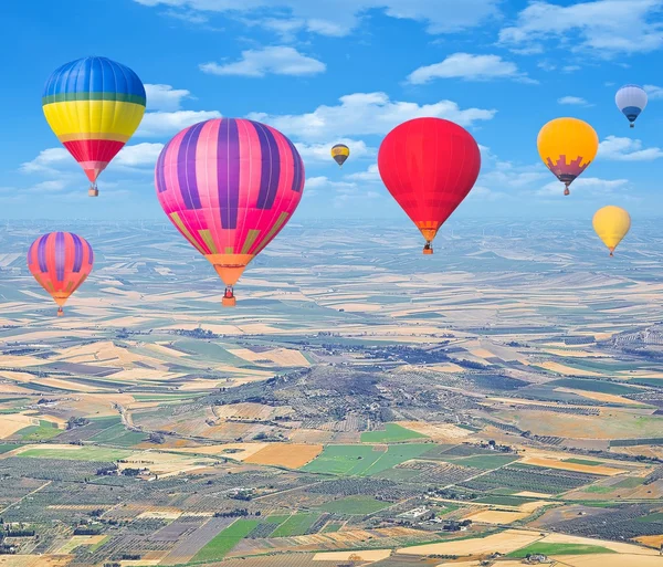 Flight of hot air balloons above the countryside. — Stock Photo, Image