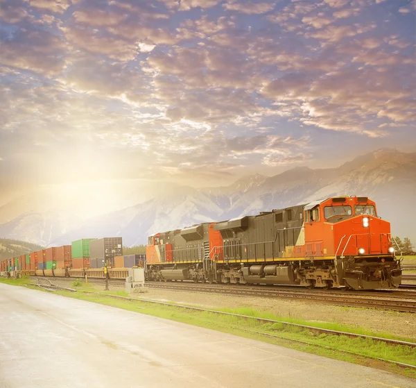 货运列车在日落时的加拿大洛矶山. — 图库照片