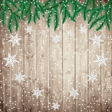 Köknar ağaç dalları ve ahşap tahta üzerinde kar taneleri.