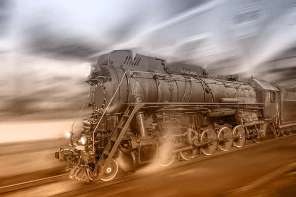 Steam train goes fast on the night station background. — Stock Photo, Image