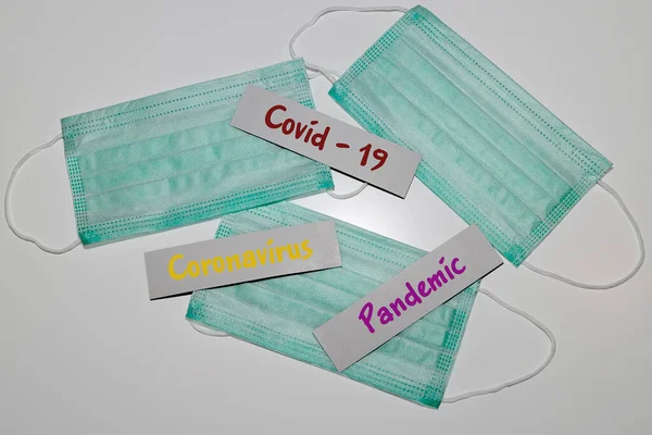 Cards with the coronavirus and pandemic Lettering. Medical protective masks. White background.