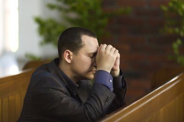 Man praying in church clipart