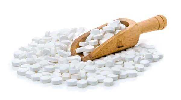 Білі таблетки в сопілці на білому тлі — стокове фото