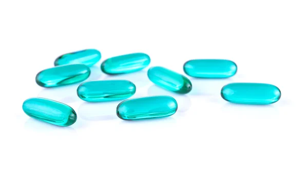 Pastillas azules transparentes contenido cápsula de la medicina sobre fondo blanco —  Fotos de Stock