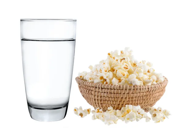 Glass of water and popcorn in basket isolated on white backgroun — Stock Photo, Image