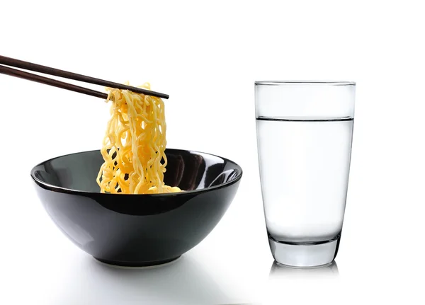 Chopsticks holding noodles and Glass of water isolated on white — Stock Photo, Image