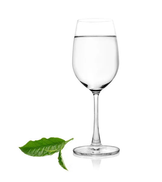 Glass of water and tea leaves ilsolated on white background — Stock Photo, Image