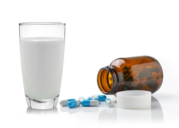 Pill and glass of milk isolated on white background — Stock Photo, Image