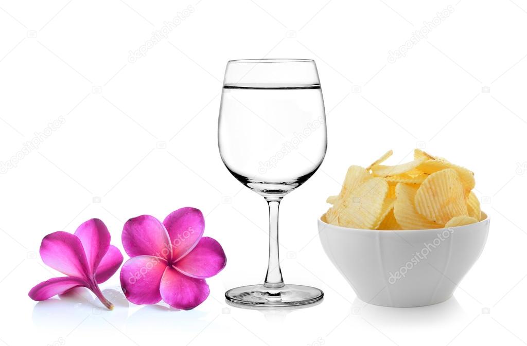 Glass of water  frangipani flower , Bowl of potato chips on whit