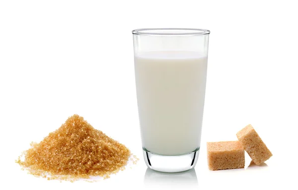 Vetro di latte e cubetti di zucchero di canna isolato su backgrou bianco — Foto Stock