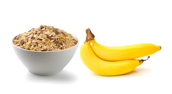 Muesli petit déjeuner placé et banane sur fond blanc — Photo