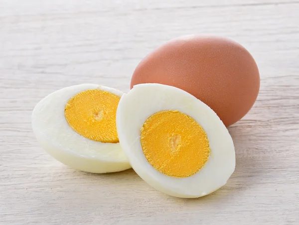 Boiled egg isolated on white wood — Stock Photo, Image