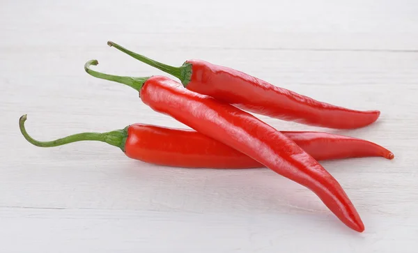 Red chili peppers on wood — Stock Photo, Image