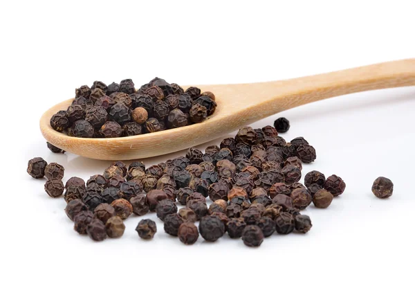 Black pepper in wooden spoon on white background. — Stock Photo, Image