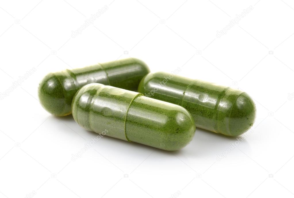 Moringa capsule pills on white background