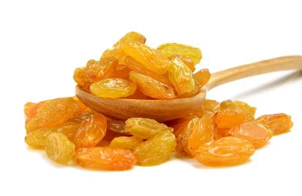 Dried raisins in the wood spoon on a white background — Stock Photo, Image