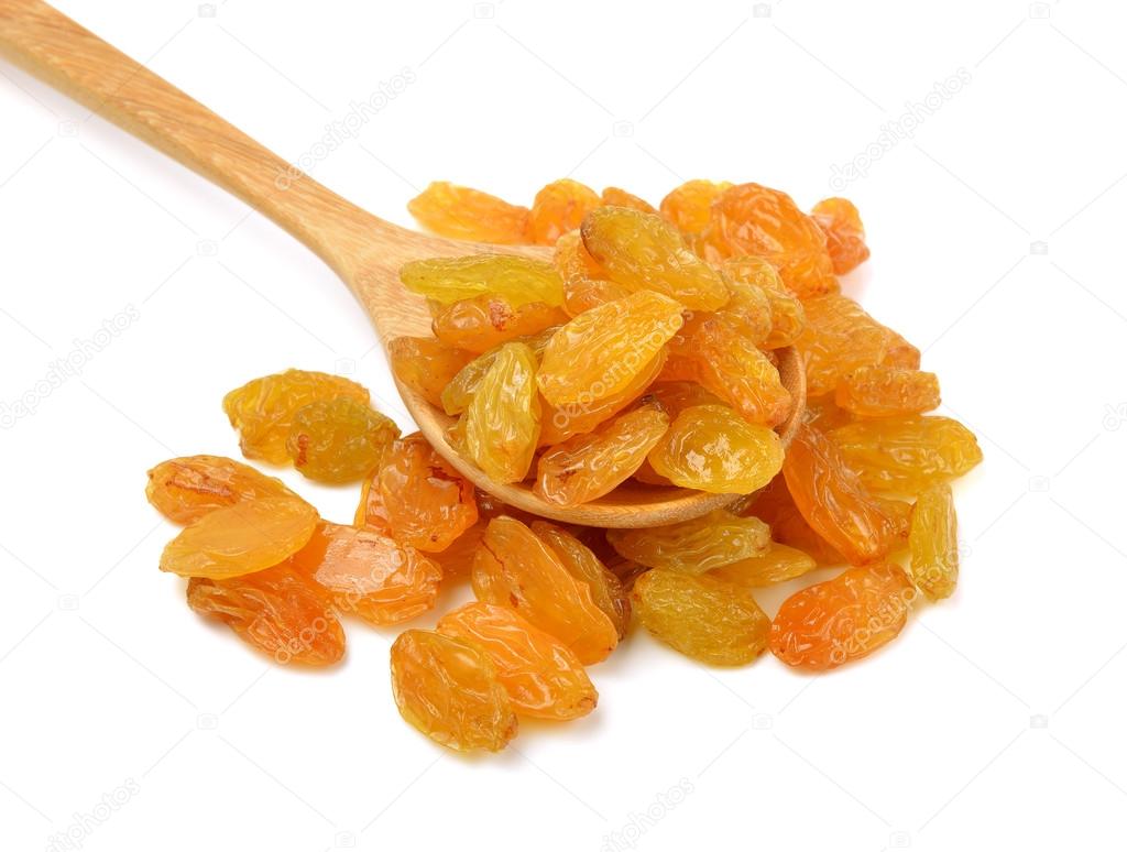 Dried raisins in the wood spoon on a white background