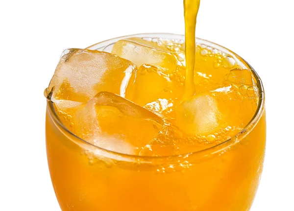 Orange juice pouring into glass — Stock Photo, Image