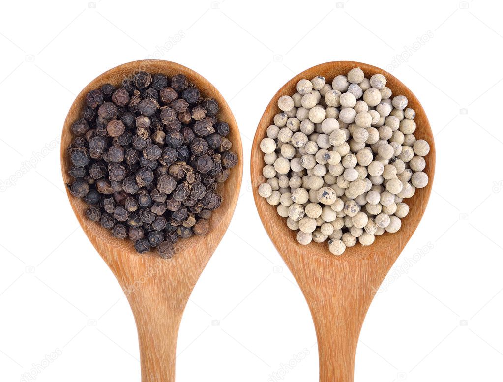 Wooden spoon and black peppercorn on white background