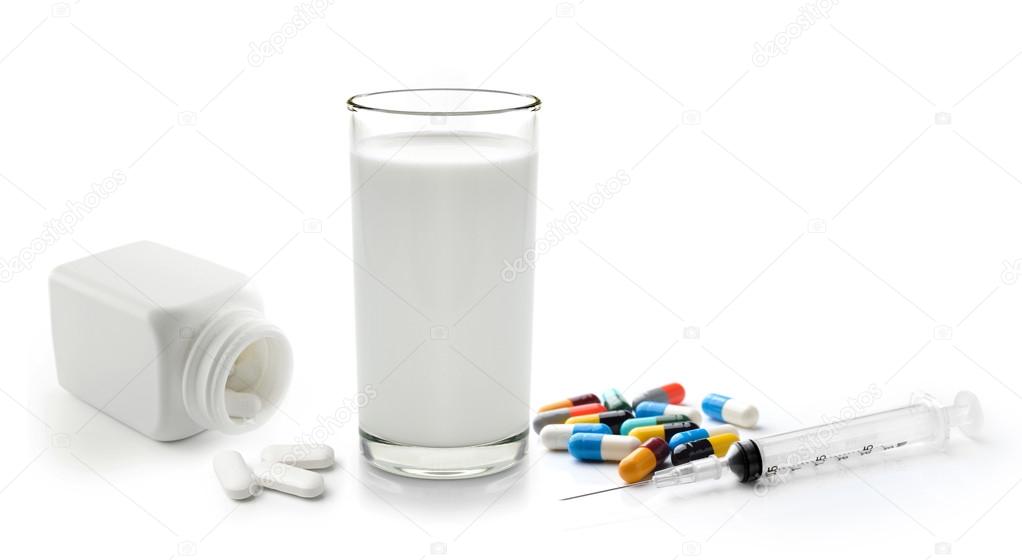 pill and glass of milk isolated on white background
