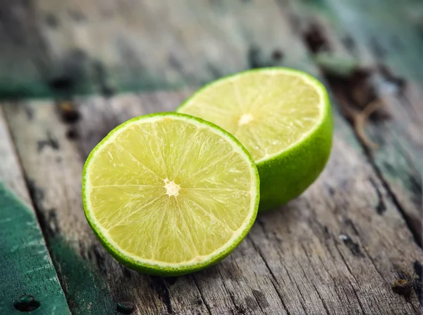 Fresh limes on wooden background