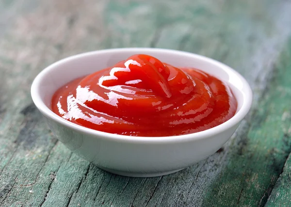 Tomato sauce on wood table — Stock Photo, Image