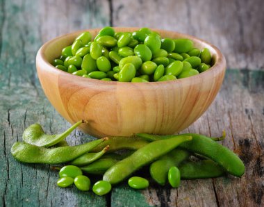 green soy beans in the wood bowl on table clipart