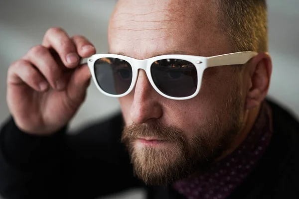 Bearded man portrait. Guy bearded in sunglasses. Close up of handsome bearded man sunglasses