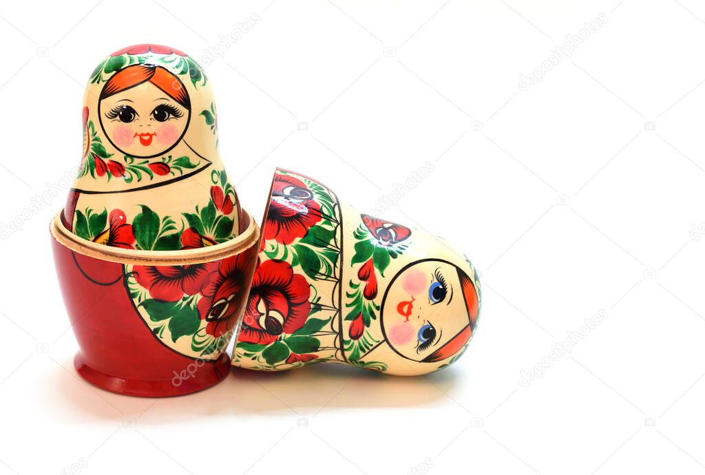 One assembled nesting doll inside another large one and a head lying near by
