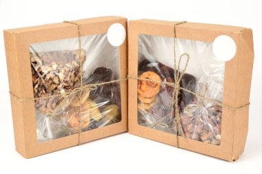 Fındıklı hediye kutuları ve kurutulmuş meyveler sicimle bağlanmış ve beyaz arka planda izole edilmiş.