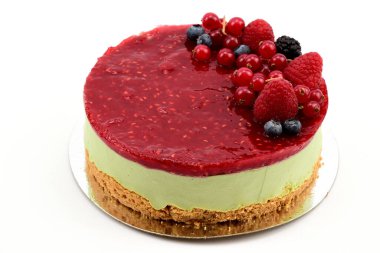 Taze ahududu, yaban mersini ve yaban mersiniyle süslenmiş doğal şam fıstığı ezmeli kek.