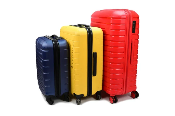 Plastic Suitcases Different Sizes Colors Wheels Arranged Row Isolated White — Stock Photo, Image