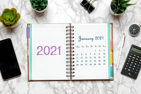 Open Calendar January 2021, glasses, cup of coffee, pen, smartphone, succulents on marble table Top view Flat lay Education, goals, resolutions, plan, small owner business concept Home workplace — Stock Photo, Image