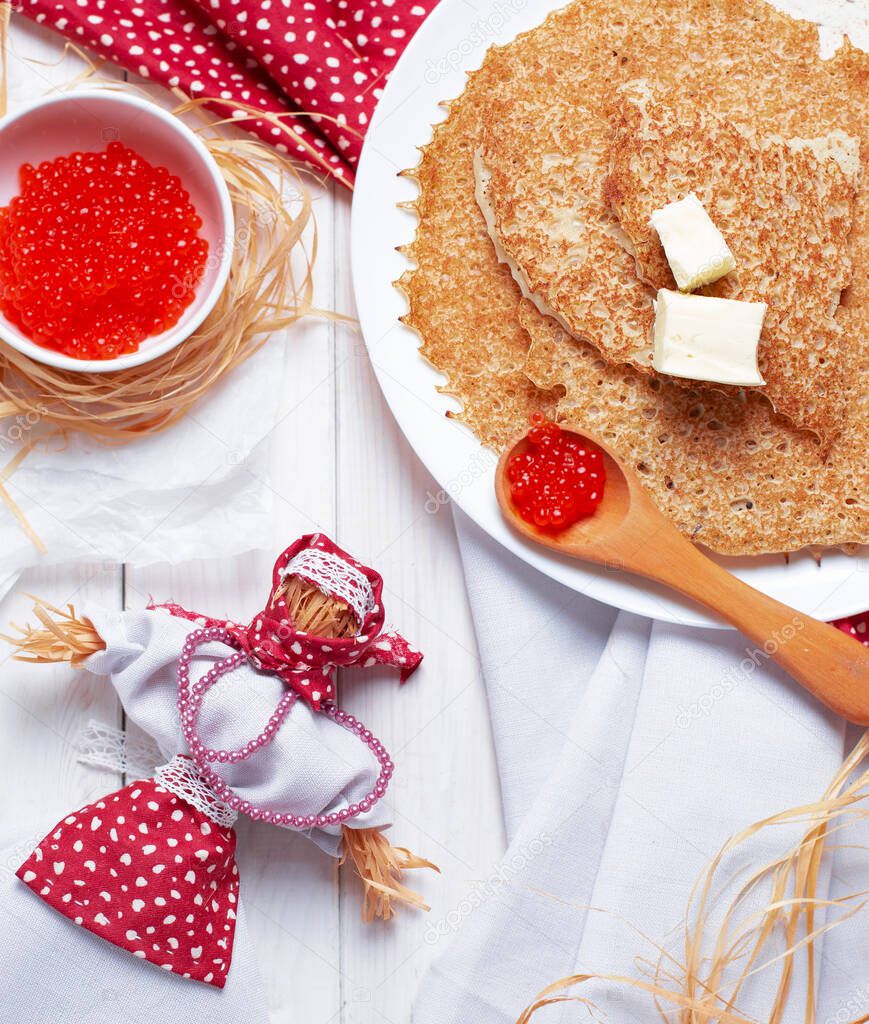Pancakes with red caviar on the white plate. Staple of yeast pancakes, traditional for Russian pancake week. Shrovetide or Maslenitsa