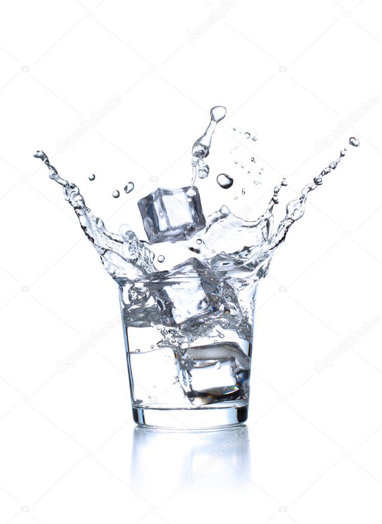Splash of clear plain water in the glass with ice