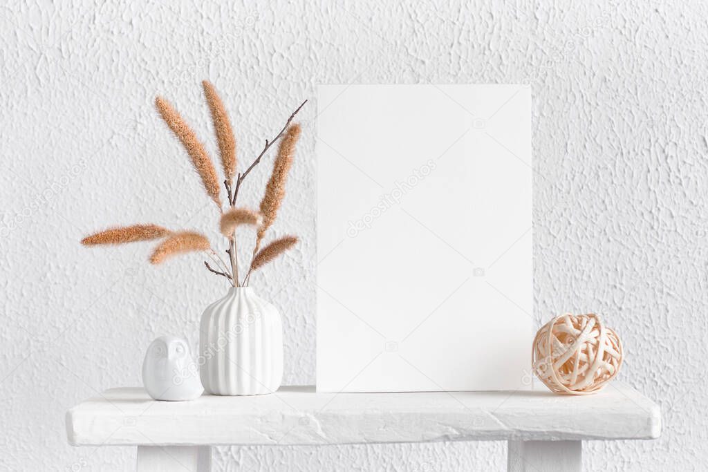 Blank mockup vertical rectangular poster with flower vase, plant and decorations on empty white wall background. Copy space, simplicity and minimal