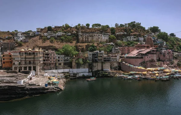 The Indian town of Omkareshwar is located in the state of Madhya Pradesh. the path, there are also temples and a tall statue of Shiva.