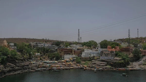 The Indian town of Omkareshwar is located in the state of Madhya Pradesh. the path, there are also temples and a tall statue of Shiva.