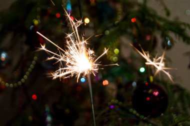 Arkaplandaki yılbaşı ağacı ışıklarına ateş yakmak, yeni yıl için bir dilek tutmak, Noel mucizeleri ve kehanetler, vaftiz. Gelenekler