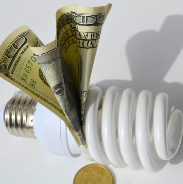 Light bulb on money background Royalty Free Stock Images