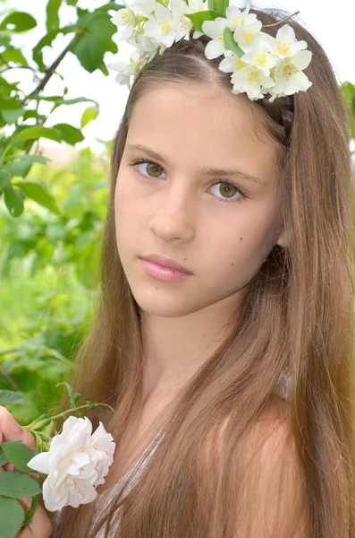 Girl with fresh flowers of jasmine in her hair — Stock Photo, Image