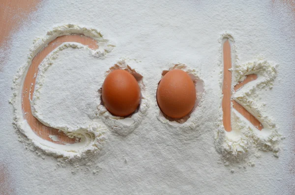 Flour and two eggs - the inscription "Cook" — Stock Photo, Image