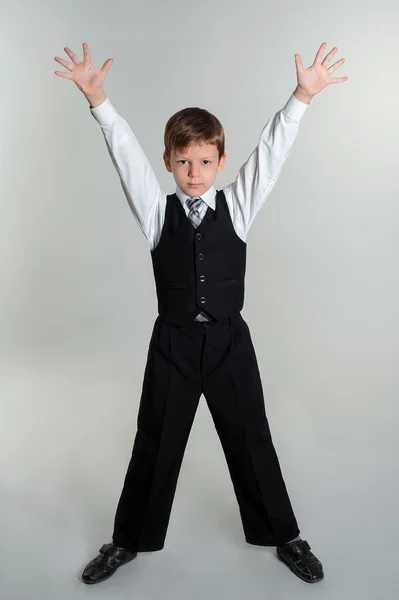 Schoolboy hands up — Stock Photo, Image