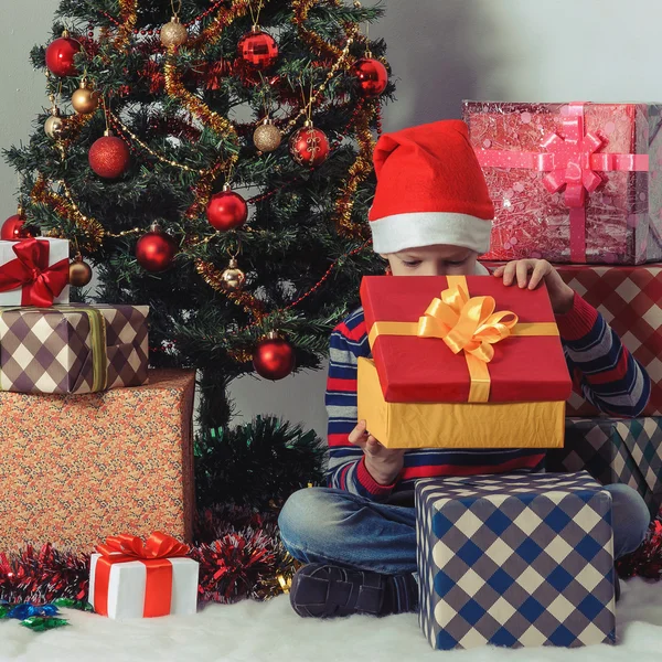 Felice ragazzo che apre una scatola regalo. Natale. — Foto Stock