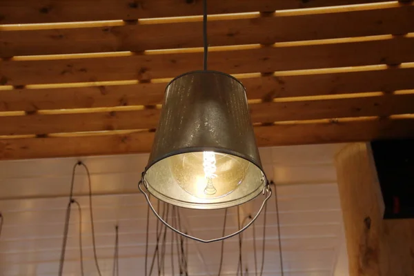 rustic decorative lamp made from an inverted iron bucket