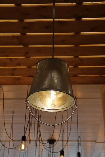 rustic decorative lamp made from an inverted iron bucket