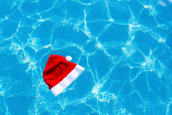 Christmas hatt flyter på vattnet i en simbassäng — Stockfoto